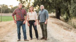 Family standing in vineyard