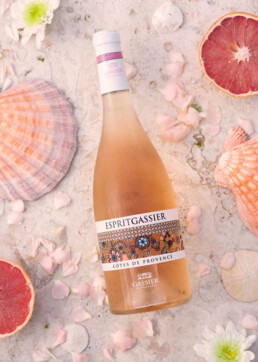 Wine bottle lying on sand at the beach