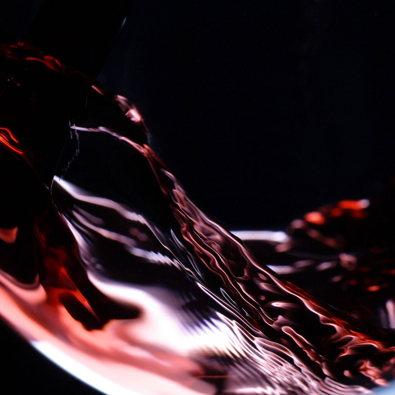 Abstract red wine splashing in wine glass