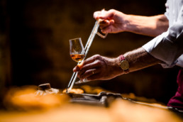 Siphoning Cognac in cellar