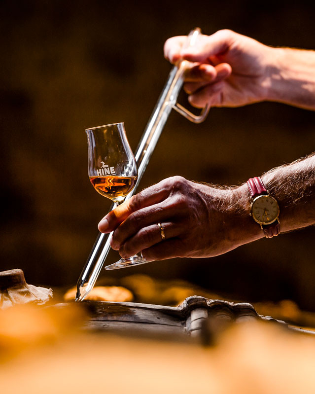 Siphoning Cognac in cellar